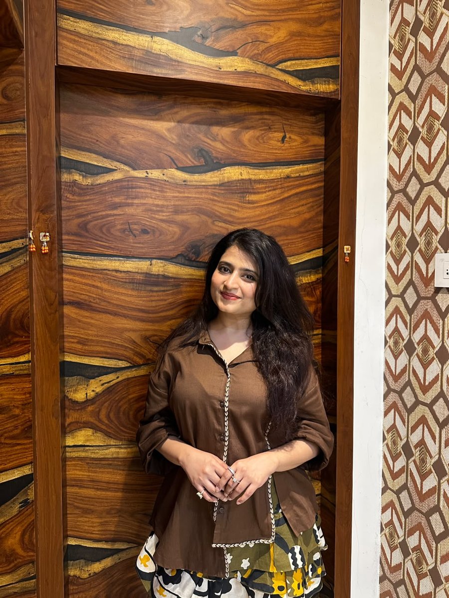 Sneha smiling in the Coffee Jute shirt